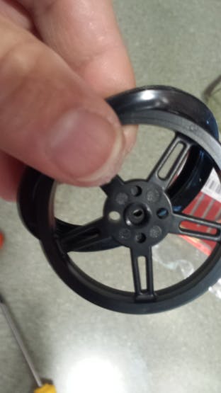 Slip rubber tire around plastic tire/rim/wheel